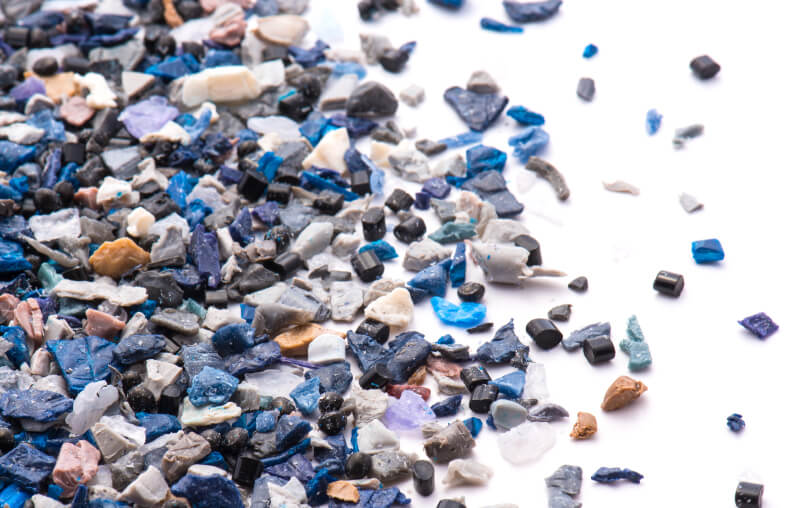 Man Using Measuring Tape in Factory Setting Man Using Measuring Tape in Factory Setting